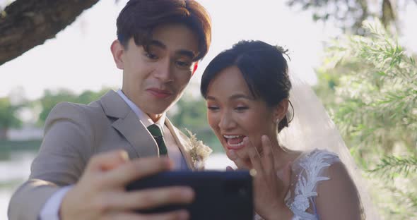 Married Couple Happily Chatting Over Video Calls With Their Friends.