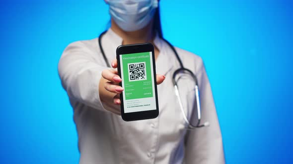 Woman Doctor in Medical Uniform Showing Vaccination Passport with Qr Code on Phone International