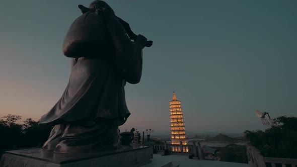 Back of Buddha and pagoda on the background at night in Bai Dinh temple Hanoi, Vietnam