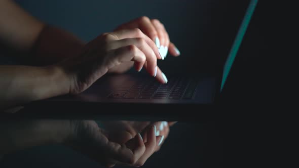 Hands or Woman Office Worker Typing on the Keyboard at Night