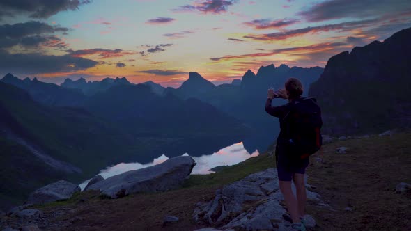 Hiker Reaches Mountain Peak, Takes Picture of Sunset