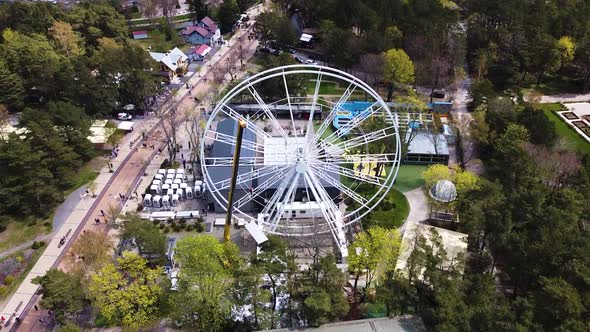 Construction process of Ferris wheel in Palanga downtown, aerial ascend view