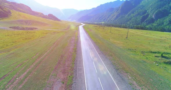 Flight Over Mountain Asphalt Highway Road and Meadow