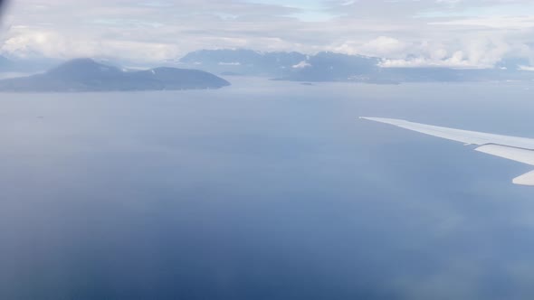 Plane turning above oceans and islands