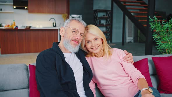 Mature Man and Woman Looking at Camera Smiling