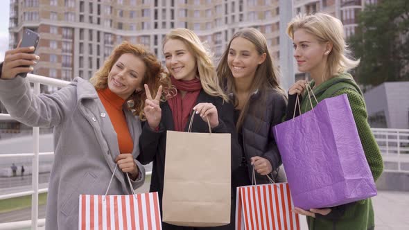 Four Beautiful Girlfriends Posing on the Street While One of Them Taking Selfie