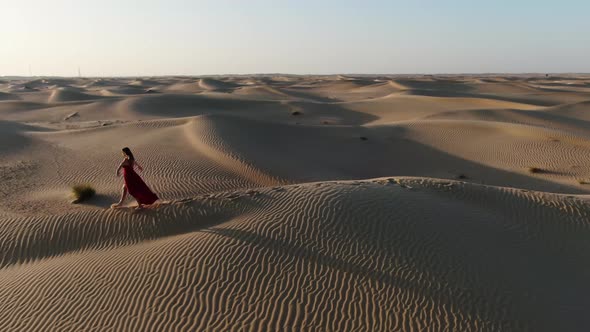 Beautiful Sunset in the Desert Woman is Walking on Sand Dunes Rub Al Khali