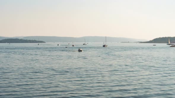 Sunset time lapse over busy waterway, boats in Oslo sea