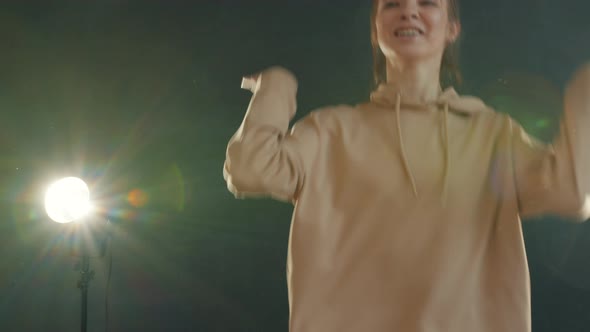 Portrait of Attractive Young Girls Dancing During Cool Modern Performance in Dark Hall