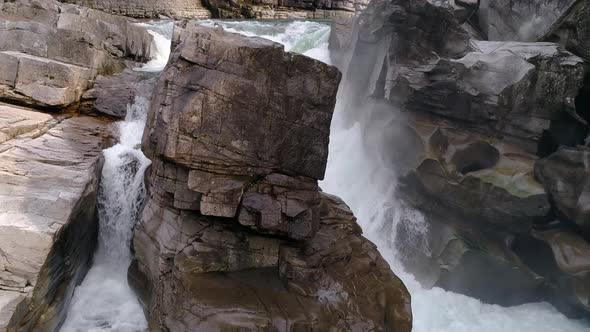 Stunning Aerial Of Drone Hovering Close Up To Rocky Waterfall Mist In 60P 4K