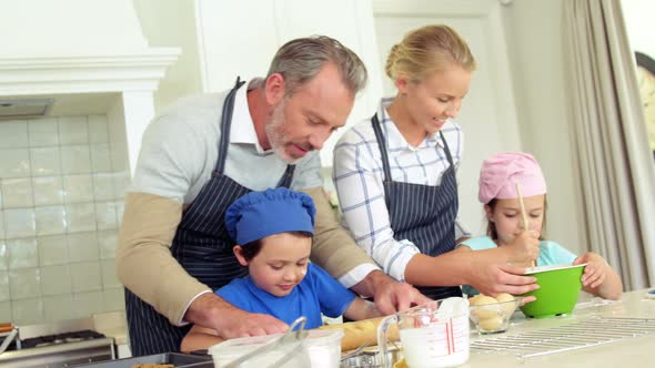 Family preparing dessert in kitchen