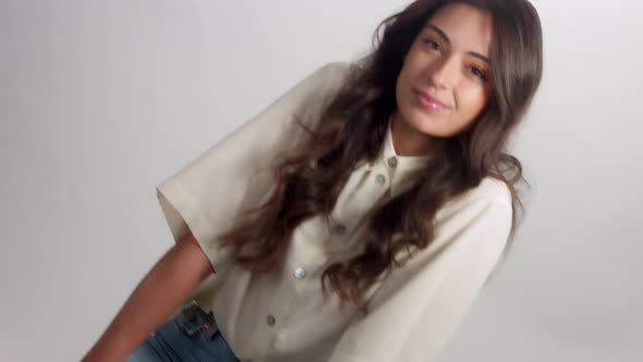 Young Brunette Woman Alone in Studio Portrait. Smiling Happy Woman