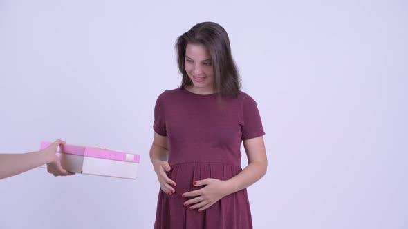 Happy Young Beautiful Pregnant Woman Getting Gift Box and Looking Surprised