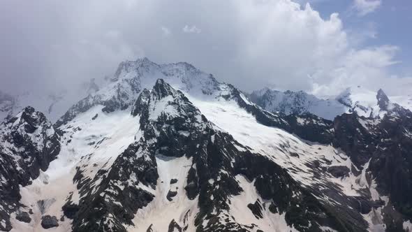 Flight above snowcapped mountains near Elbrus