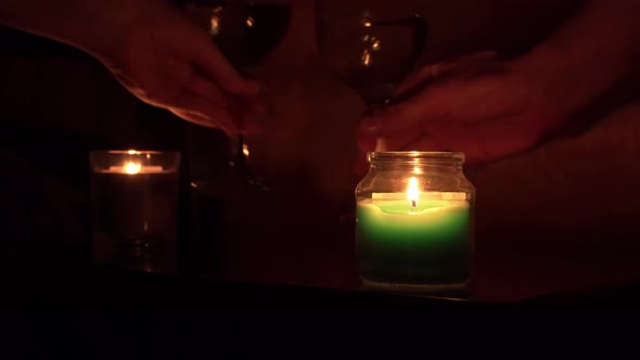The Guy and the Girl Drink Wine By Candlelight in the Evening Near the Bed