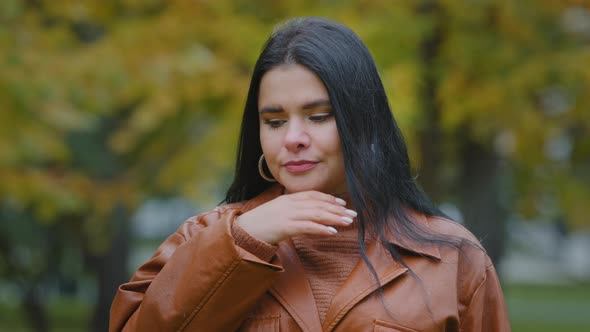 Unhealthy Young Hispanic Woman Standing Outdoors Coughing Suffering From Seasonal Flu or Chronic