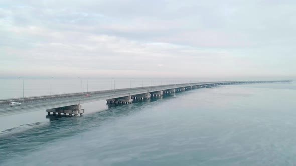 Aerial Drone View of Lowwater Bridge Across the Bay with Moving Car