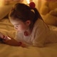 Cheerful Girl Browsing Tablet on Bed in Evening - VideoHive Item for Sale