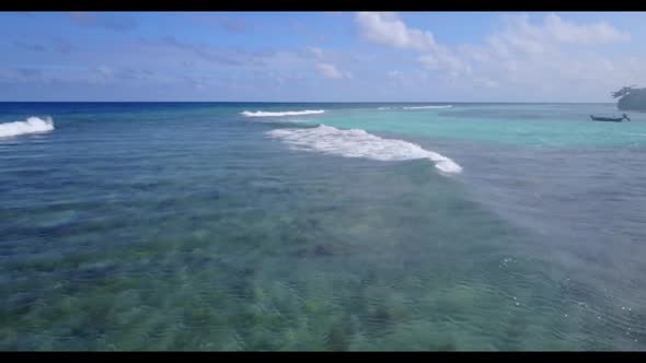 Aerial drone shot panorama of tropical island beach journey by blue ocean with white sandy backgroun