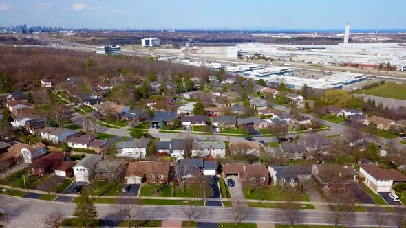 Aerial rise over a suburban neighborhood during early spring.