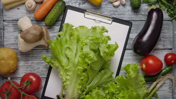 Cook Taking Lettuce From Table with Clipboard