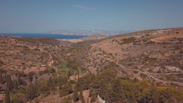 Aerial Drone Shot Revealing the Various Landscapes of the Island of Lefkes Greece with the Ocean in