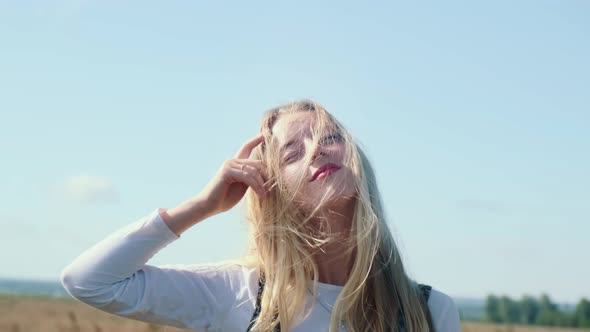 A Young Girl in a Beautiful Dress Against the Blue Sky