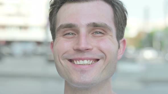 Face Close Up of Smiling Young Man Outdoor