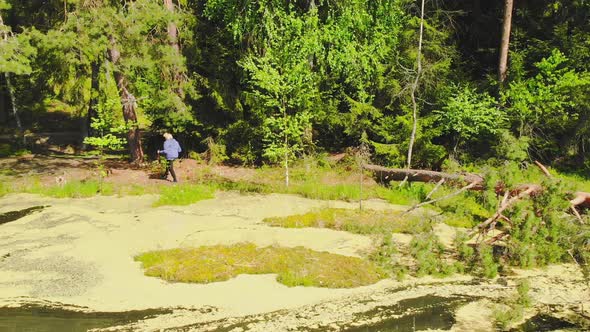 Elderly Woman Enjoy Nordic Walking In Nature