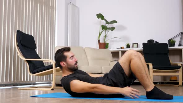 Man Doing Sport at Home, He Is Making Exercises for the Abs