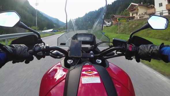 POV of Biker Rides a Motorcycle on a Scenic Mountain Road in Austria