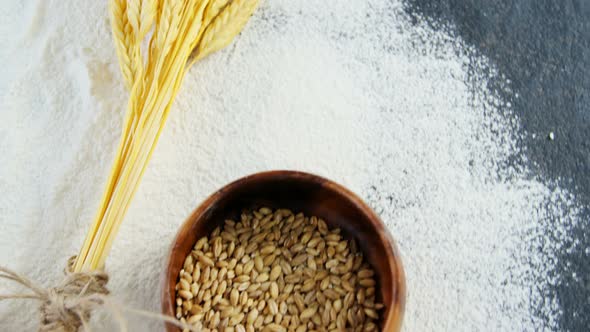 Wheat grains, sesame and flour in bowls