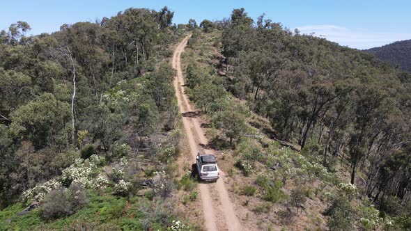 High Drone shot of 4WD Toyota Driving up a Mountain in the bush, Near Lake Eildon Victoria Australia