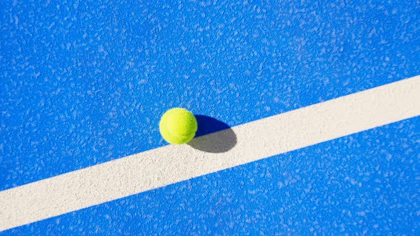 Tennis court. Drone view of a ball with the whole area. Zoom-out. Blue and green