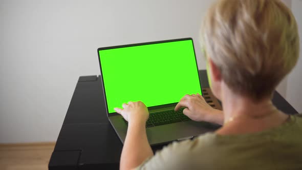 Elderly Woman Working on Laptop Green Screen Mockup