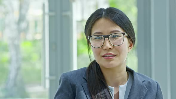 Asian Businesswoman Chatting with Colleague