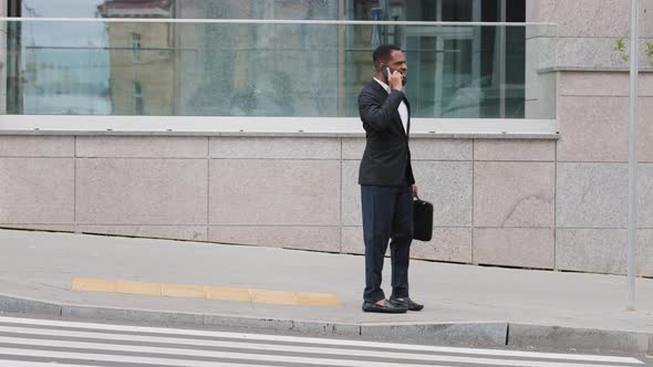 Millennial African American Man Young Businessman Holding Smartphone Having Conversation on Phone