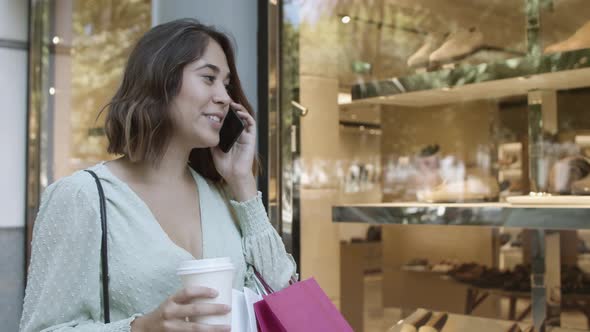 Happy Latin Woman Talking on Smartphone and Smiling