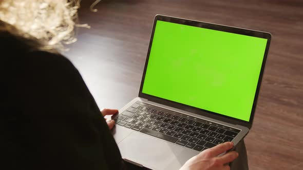 Close Up of a Woman Watching Laptop with Green Screen Chroma Key Indoors