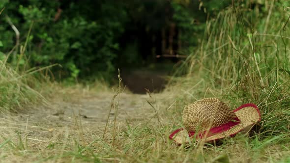 A Guy Tries to Catch a Straw Hat That Slips Out of His Hands