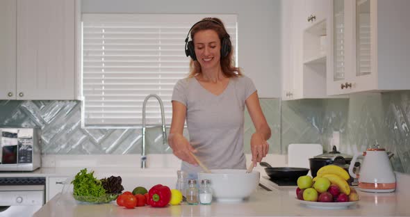 Portrait of Cheerful Woman Singing Song in Whisker on Domestic Kitchen in Slow Motion