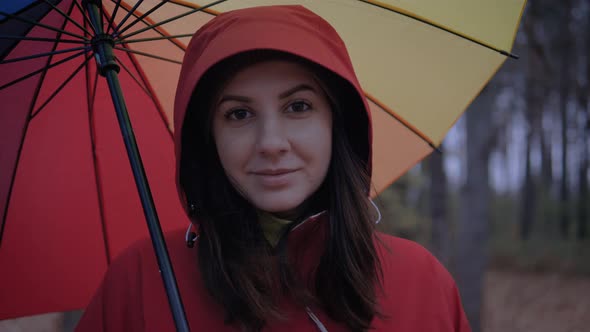 Portrait Of Caucasian Woman In Hood And Under Umbrella In Autumn On The Street