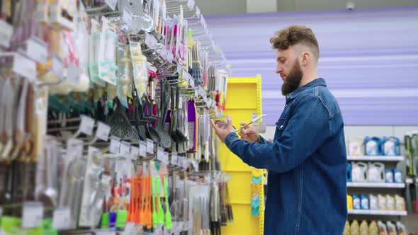 Man Buying Kitchen Utensils in Homeware Store