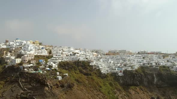 Aerial view of traditional white houses over cliff on Santorini island, Greece.