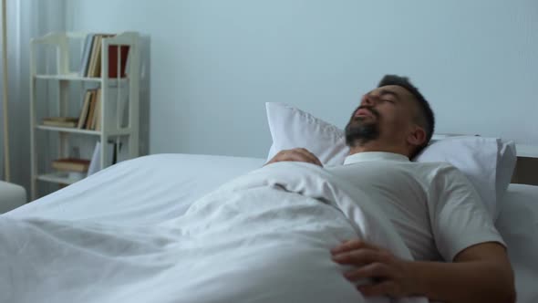 Man in Bed Seeing Nightmares While Asleep, Former Soldier Dreaming About War
