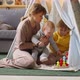 Mom and Little Kids Playing with Toy in Teepee - VideoHive Item for Sale