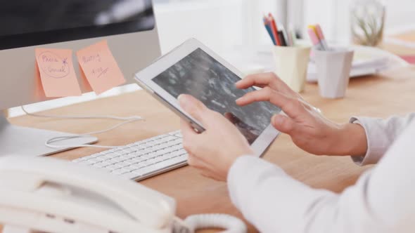 Businesswoman using digital tablet at her desk