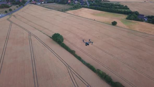 Aerial Shot of Black Drone Flying Over By the Brown Fields