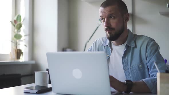 Young Hipster Bearded Successful Business Guy Receiving Good News in Business