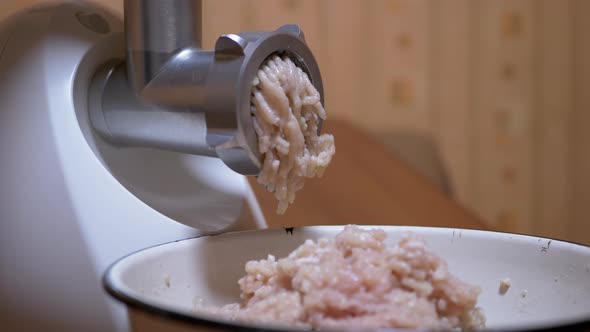 Electric Meat Grinder Scrolls Raw Chicken Fillet for Minced Meat Through a Sieve